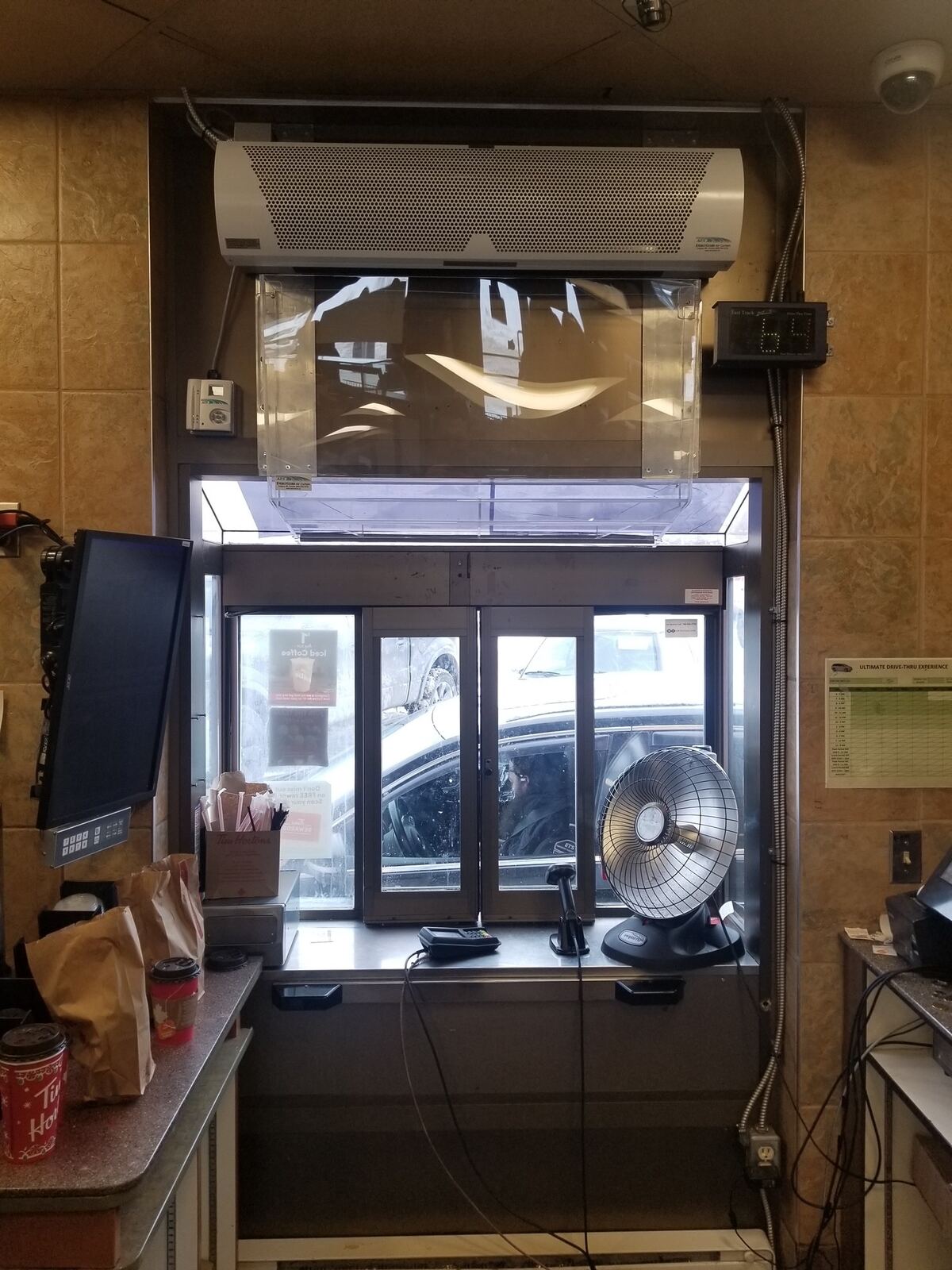 Drive-through window air curtain