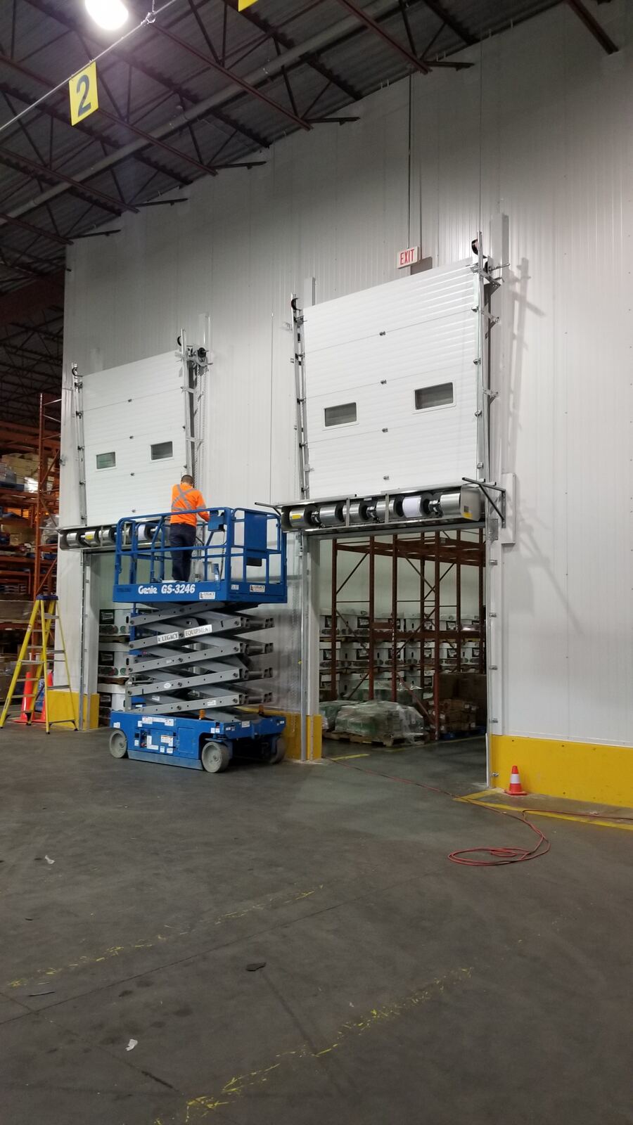 Technicians installing freezer doors lift